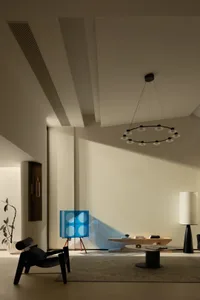 A modern living room featuring glass furniture and steel accents.