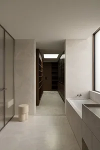 A modern marble bathroom with a minimalist design.
