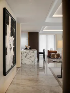 Modern luxurious living room with marble flooring and furniture, featuring a plush sofa and stylish decor.
