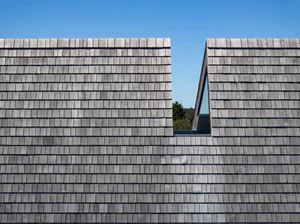 Modern building exterior featuring grey shingles
