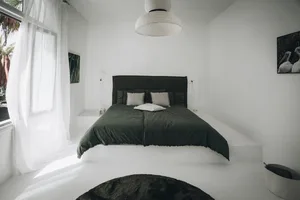 Modern minimalist bedroom with neutral colors and cotton blend bedding.