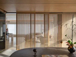 Minimalist living room with wooden paneling and bamboo plants