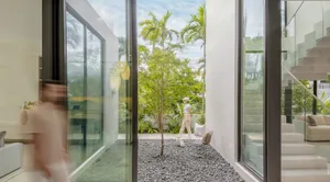 A modern interior space featuring glass elements and minimalist design.