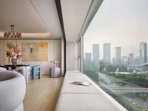 Modern living room with large windows overlooking a cityscape.