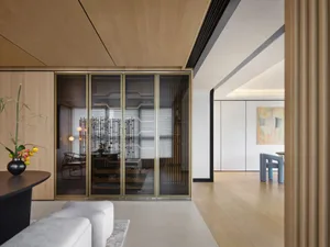 Modern living room with wooden features, including floor and furniture.