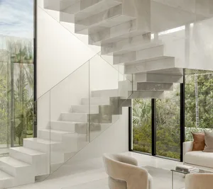 A modern interior space featuring a minimalist white marble staircase with glass railings, leading to a bright, airy room wit