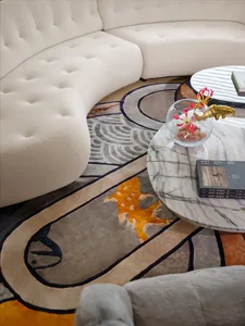 A modern minimalist living room with a white curved sofa and a colorful abstract carpet