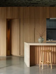 A modern residential kitchen featuring a wooden counter and floor.
