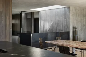 Industrial restaurant interior with concrete walls and marble table