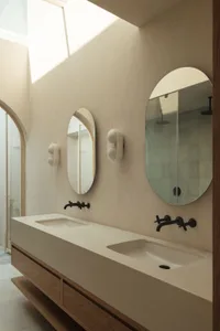 Modern bathroom featuring concrete countertops and marble sinks