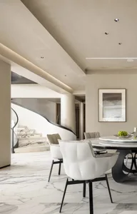 Modern dining room featuring marble flooring, table, and chairs.