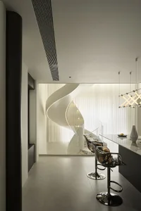 Modern kitchen featuring a white marble bar counter with sleek, black bar stools.