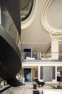A modern living room features a black spiral staircase, marble floor, and minimalist furniture.