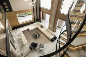 A modern living room with marble flooring and furniture.