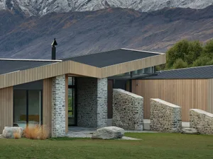 A modern residential house featuring wooden and stone materials.