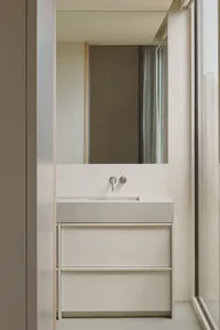 Modern bathroom featuring concrete vanity and metallic faucet