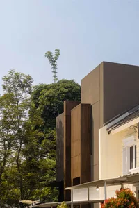A modern building exterior featuring wooden and concrete materials.