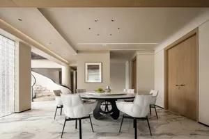 Modern dining room with marble table, white leather chairs, and black base