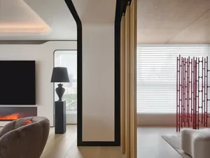 Modern living room featuring a fireplace and minimalist decor, with a view of the city.