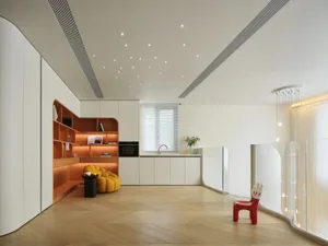 Modern living room with wooden floors, white walls, and orange shelves.