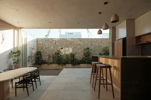 Modern minimalist residential interior with concrete, wooden, and stone elements