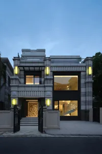 A modern residential home featuring concrete, glass, and stone materials.