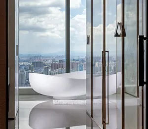 Modern bathroom featuring a luxurious glass enclosure with a panoramic city view.