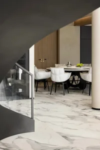 Modern dining room with marble floor and table.