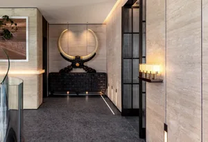 Modern entrance hall with marble flooring, walls, and large decorative bull horns