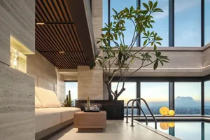 Modern spa with tile and concrete floors, glass walls, and a swimming pool.