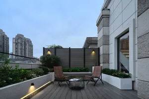 A contemporary roof deck featuring timber laminate flooring, outdoor furniture, and landscaping.