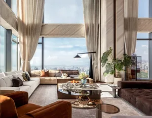 Modern living room with glass, marble, and leather finishes.