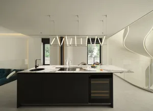A modern kitchen featuring a large island with a marble countertop and black cabinets.