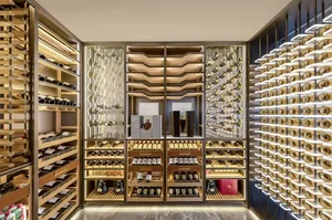 A modern, luxurious wine cellar with wooden shelves, glass cabinets, and metallic accents.