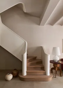 Modern staircase with wooden steps and white railings.