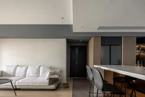 Modern minimalist living room featuring a white L-shaped sofa, wooden floor, marble coffee table, and metal frame.