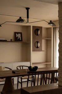 Modern residential interior featuring wooden shelves and furniture, designed for comfort and style.