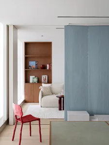 A modern living room featuring wood, leather, and marble elements.