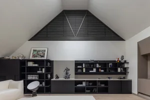 Minimalist living room featuring concrete flooring and wooden furniture.