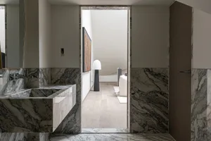Modern bathroom with marble floors and suite, showcasing contemporary design elements