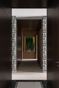 A modern interior corridor with wooden walls and patterned wallpaper