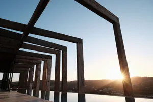 A sunset view framed by wooden architectural structures.