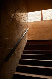 A concrete stairwell with a metal railing.