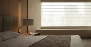 Modern minimalist bedroom with textured bedding and soft lighting