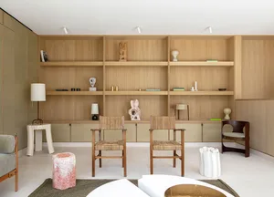 Modern minimalist living room featuring concrete and wooden furniture, with a focus on a white and brown coffee table and a t