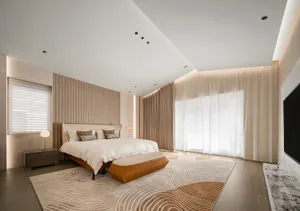 A modern bedroom features a brown leather bed, white curtains, and a patterned rug.