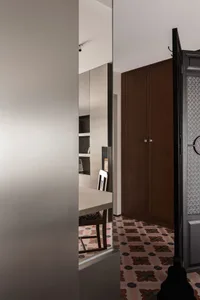 Modern dining room featuring a table and chairs with cement tiles flooring.