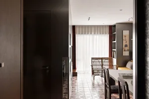 Modern dining room with ceramic tile flooring, a wooden dining table, and a large window with red curtains.