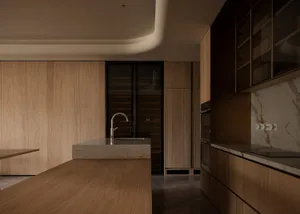 Modern residential kitchen with marble countertops and wood laminate cabinets
