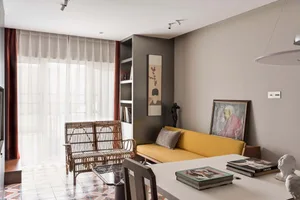 A modern living room featuring neutral-colored furniture and decor.